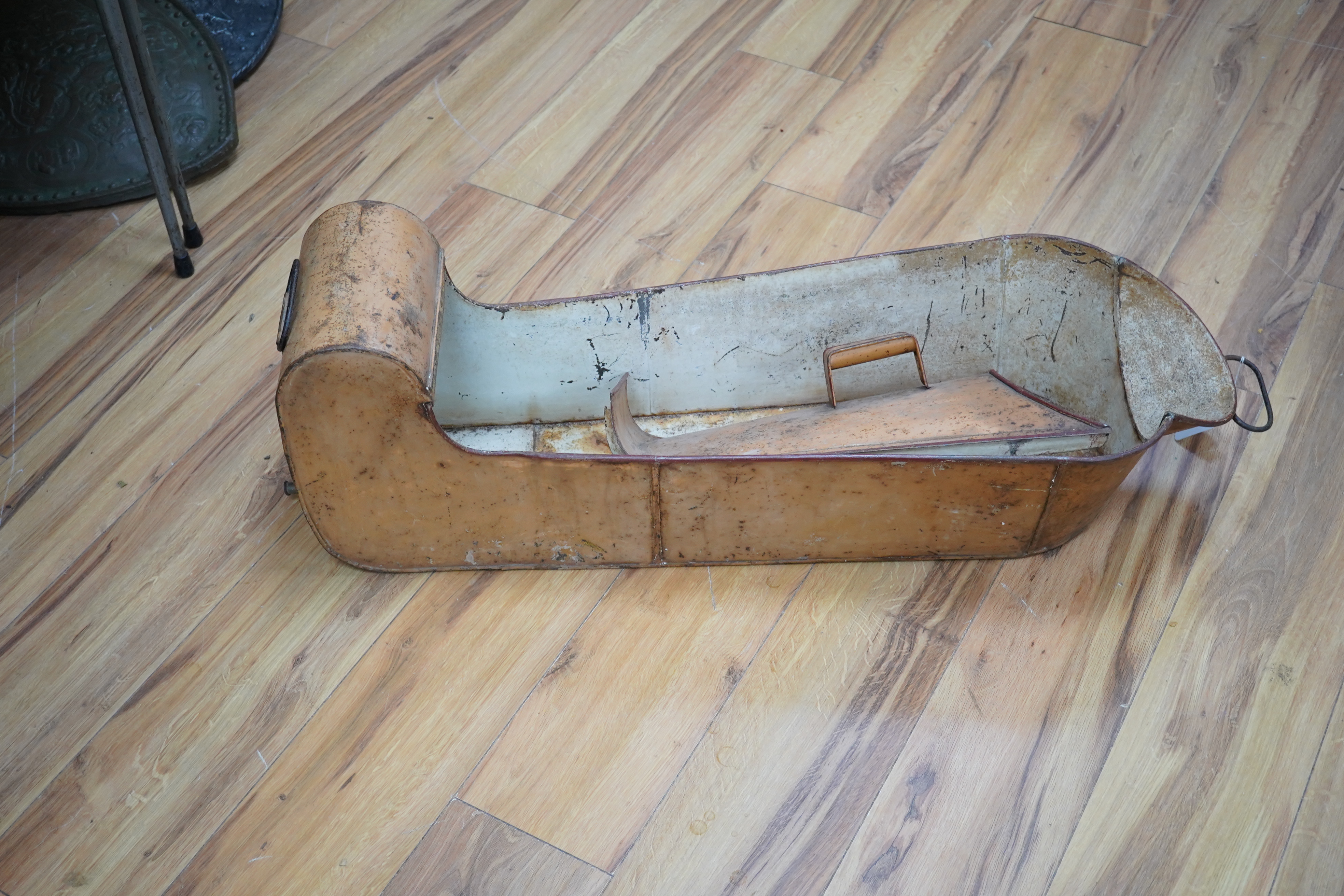 A WWII tin leg bath, with cover and tap to foot end, length 88cm. Condition - poor to fair, surface rust overall.